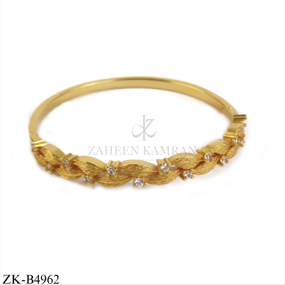 GOLD TONE BANGLE WITH TWISTED LEAF PATTERN