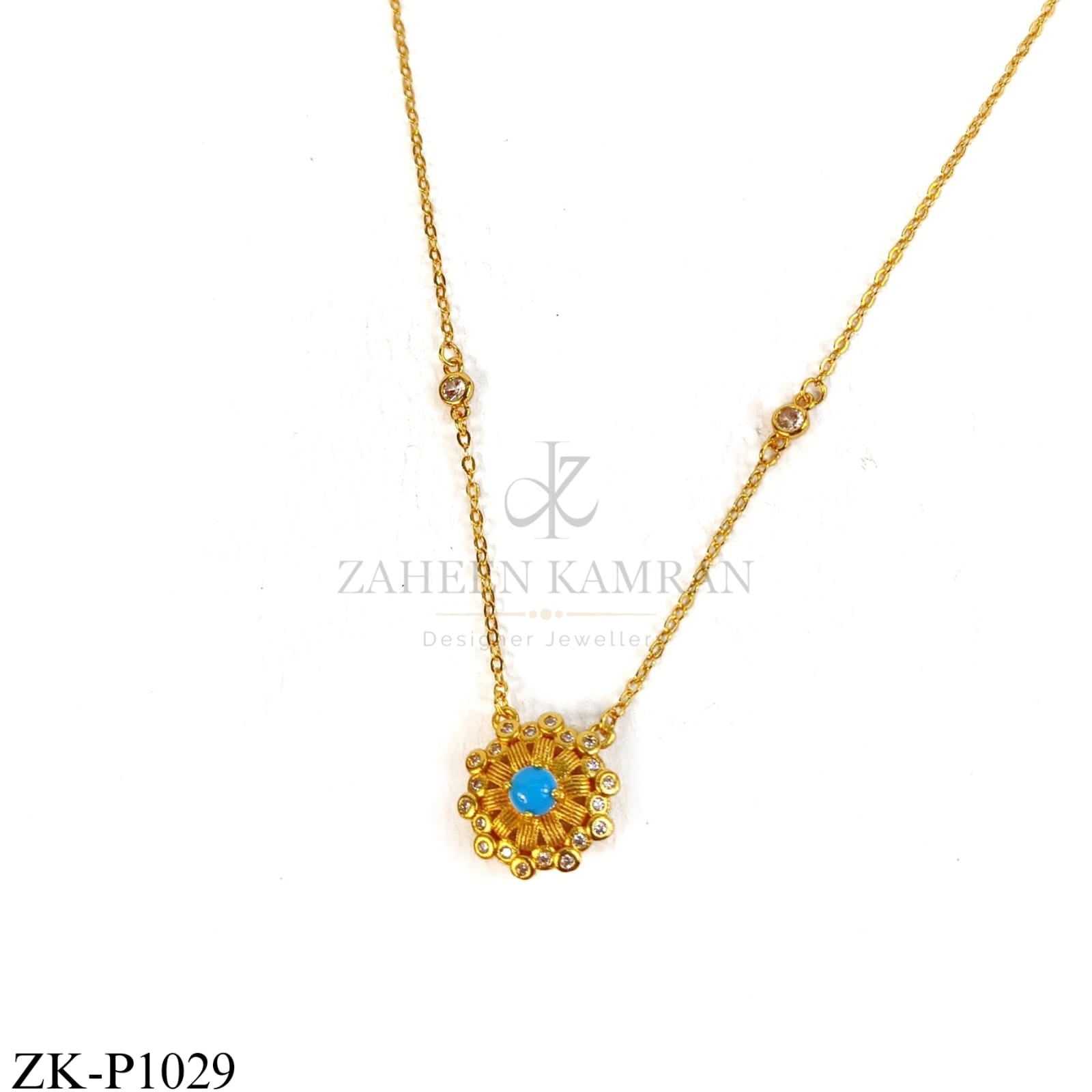 Gold sun-shaped pendant with blue centre stone - Zaheen Kamran