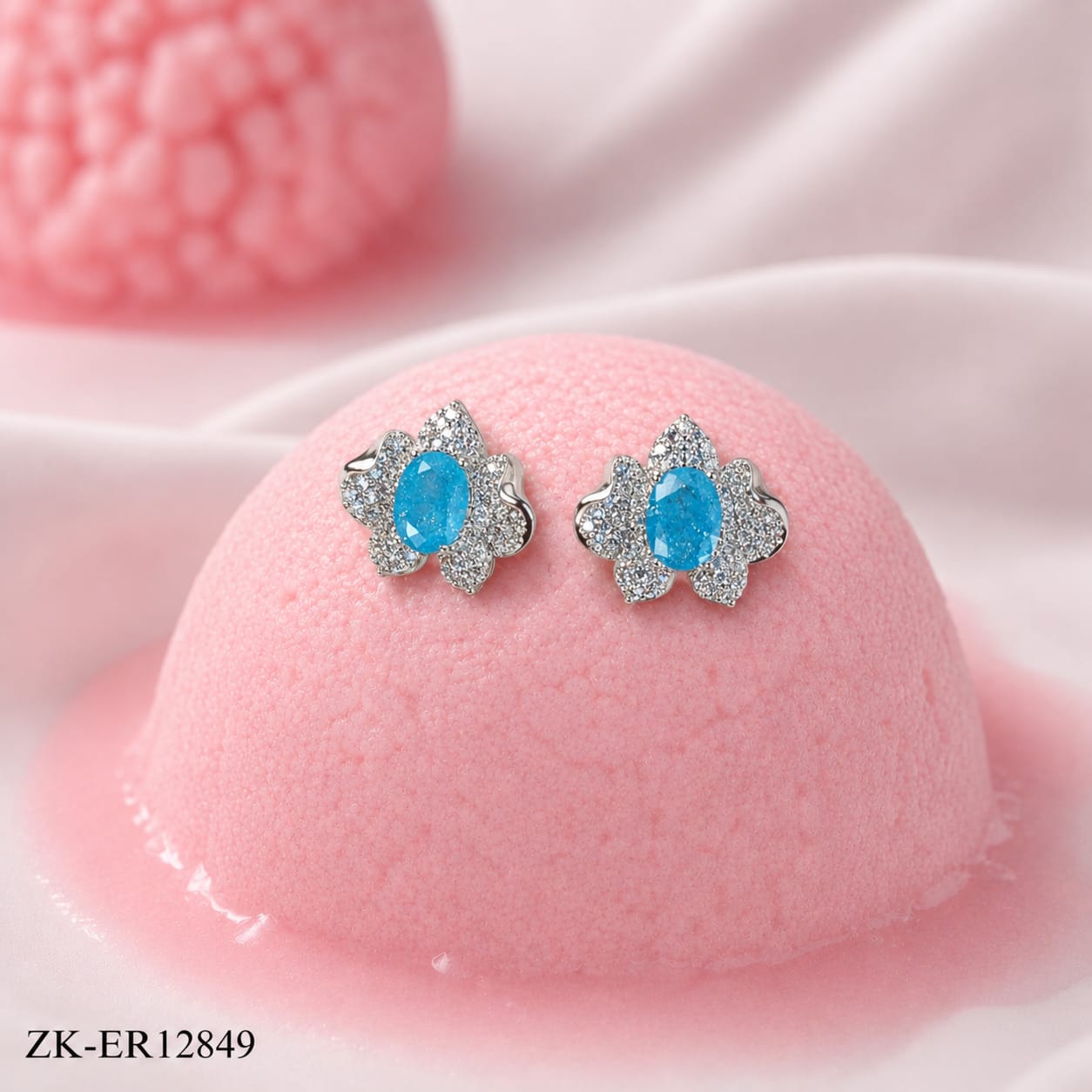 BRIGHT BLUE STONE IN A SILVER FLORAL SHAPE EARRINGS
