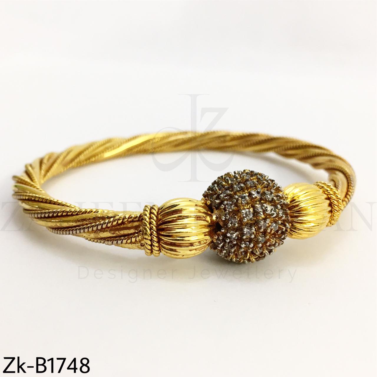 Twisted golden bangle