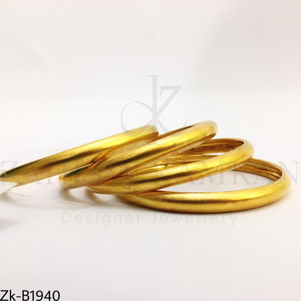 Broad golden bangles