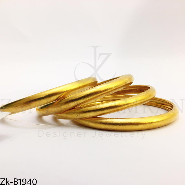 Broad golden bangles