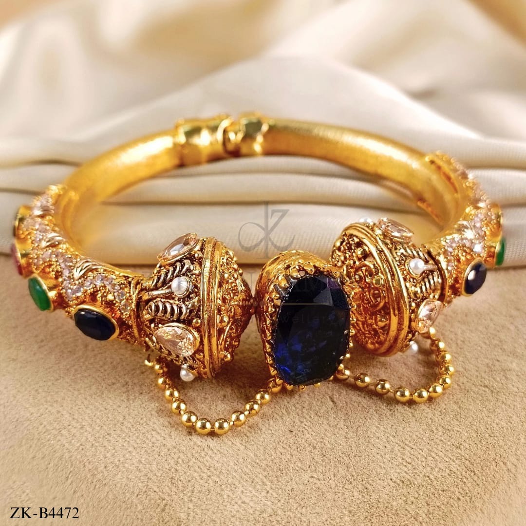 Handcrafted 22k gold plated bangle studded with sapphire, emerald and champagne.
Note "Actual product colour may vary slightly from the image"