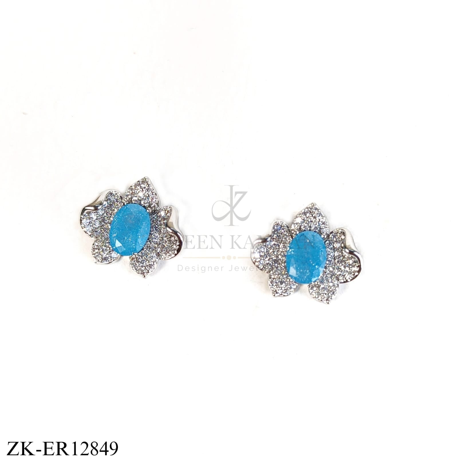 BRIGHT BLUE STONE IN A SILVER FLORAL SHAPE EARRINGS