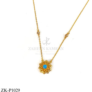 Gold sun-shaped pendant with blue centre stone - Zaheen Kamran