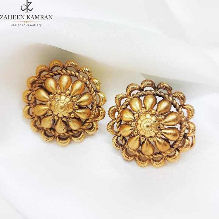 Golden floral studs.