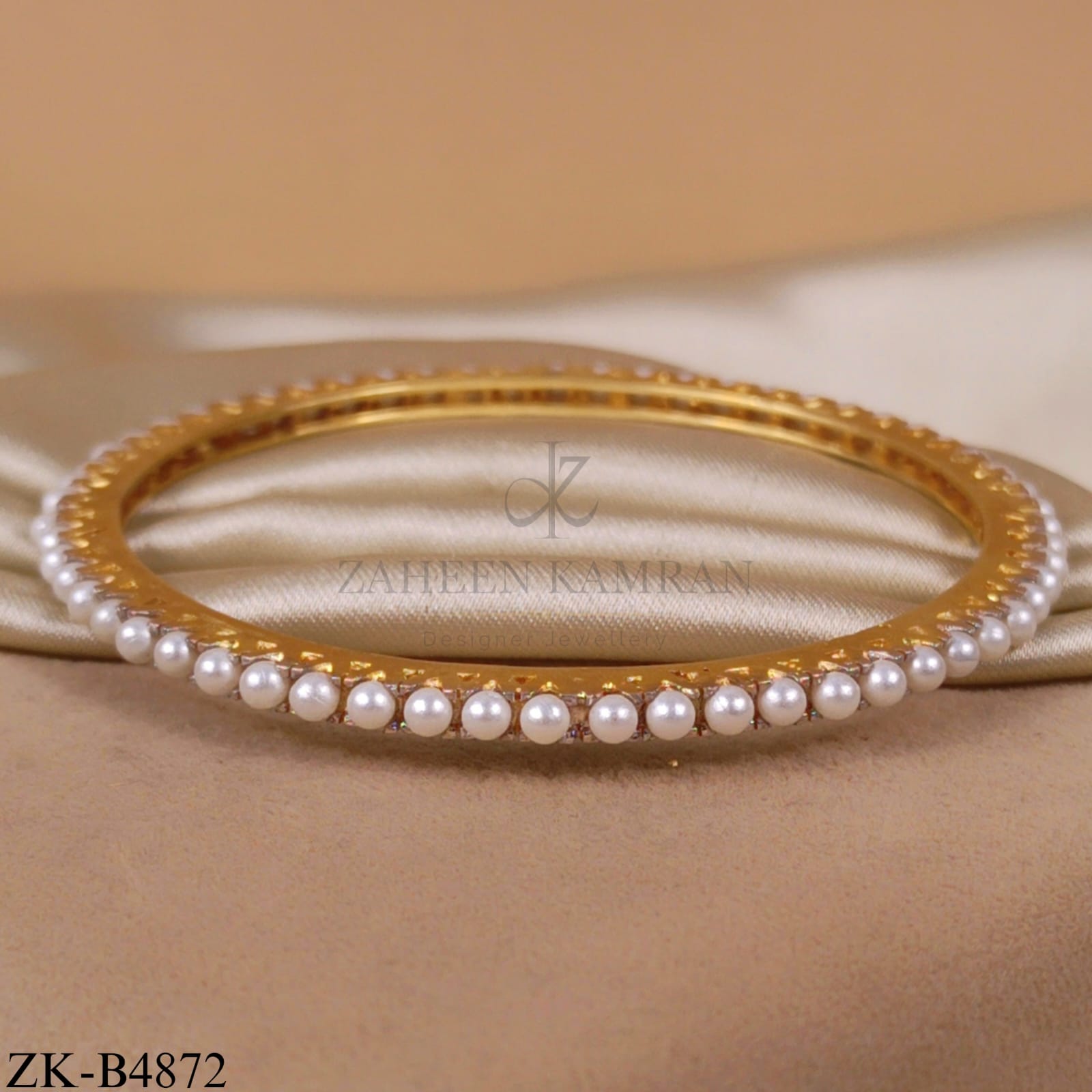 PEARLS STRAND ON GOLDEN BANGLE