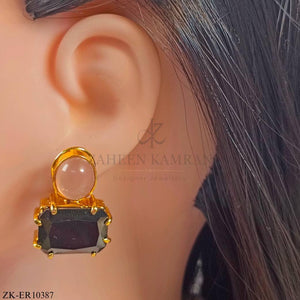 Earrings studded with sapphire and pink stones